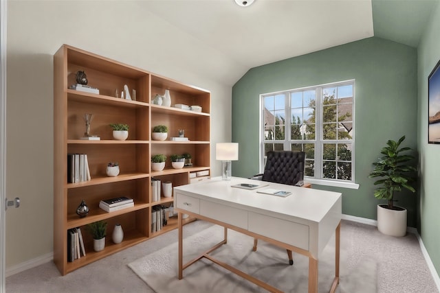 office space with lofted ceiling and light colored carpet