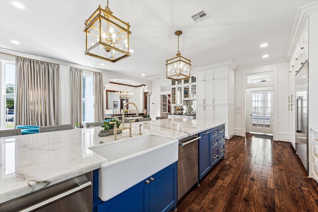 kitchen with white cabinets, dark hardwood / wood-style flooring, stainless steel dishwasher, pendant lighting, and blue cabinets