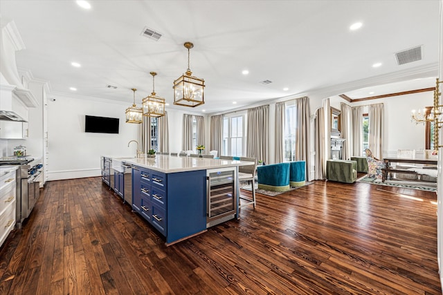 kitchen with a large island, wine cooler, a breakfast bar area, blue cabinetry, and dark wood-type flooring