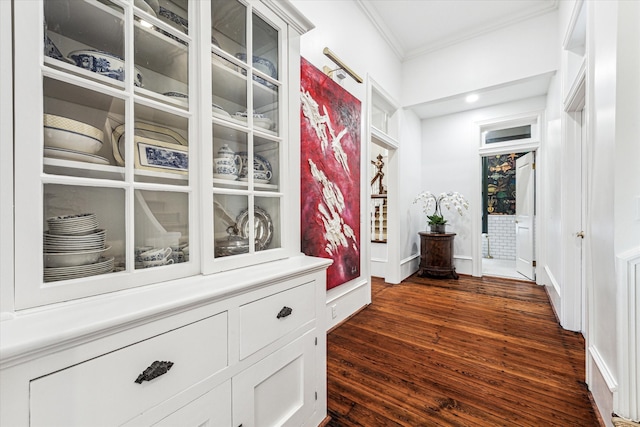 corridor with crown molding and dark wood-type flooring