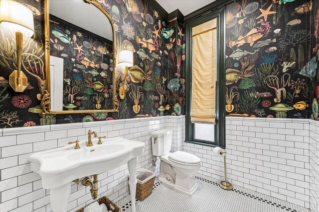 bathroom featuring tile walls, toilet, and tile patterned flooring