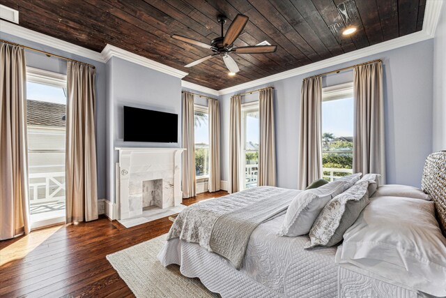 bedroom featuring ceiling fan, multiple windows, and dark hardwood / wood-style flooring