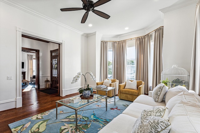 living room with crown molding, ceiling fan, and dark hardwood / wood-style flooring