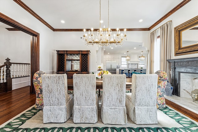 dining room with crown molding, a chandelier, and hardwood / wood-style floors