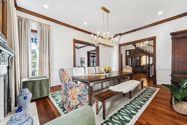 dining area with ornamental molding, a notable chandelier, and dark hardwood / wood-style floors