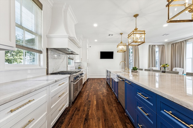 kitchen featuring blue cabinetry, premium range hood, stainless steel appliances, and white cabinetry