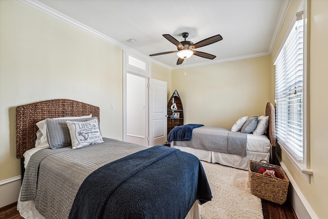 bedroom featuring ornamental molding, dark wood-type flooring, and ceiling fan