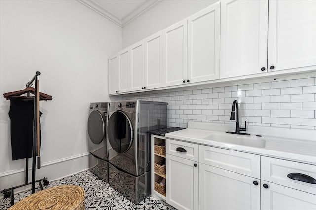 clothes washing area featuring ornamental molding, sink, light tile patterned flooring, cabinets, and washing machine and dryer