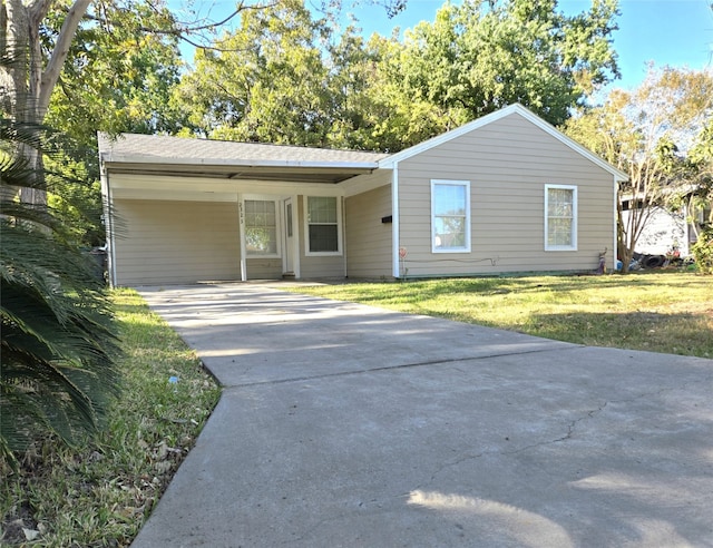 ranch-style home featuring a front yard and a carport