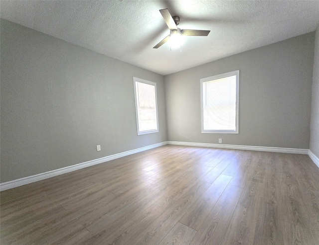 spare room featuring ceiling fan, a textured ceiling, and hardwood / wood-style floors