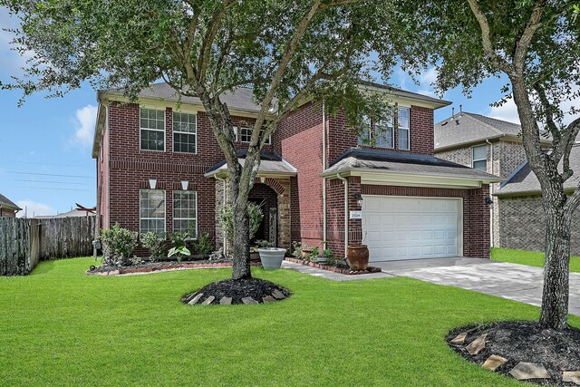 view of front of home featuring a front yard and a garage