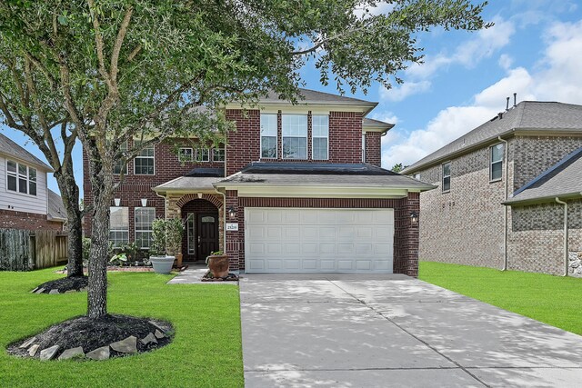 front facade with a front yard and a garage