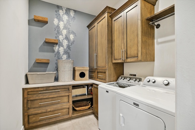 laundry room featuring cabinets and washing machine and dryer