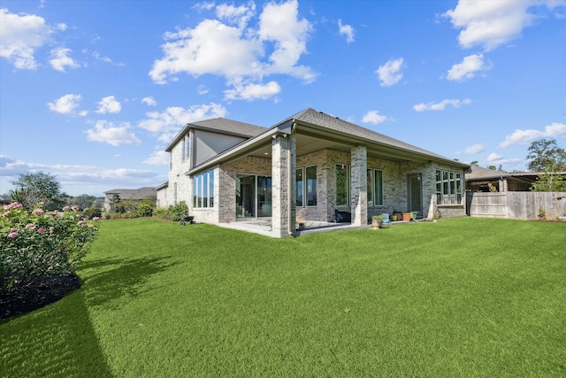 rear view of property featuring a yard