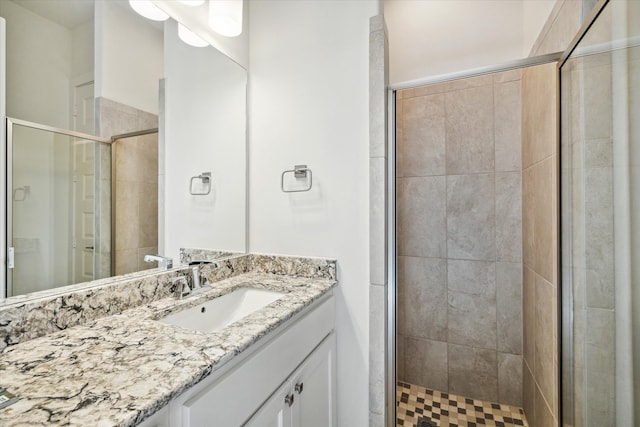 bathroom featuring vanity and an enclosed shower