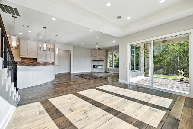 unfurnished living room featuring a fireplace and dark hardwood / wood-style floors