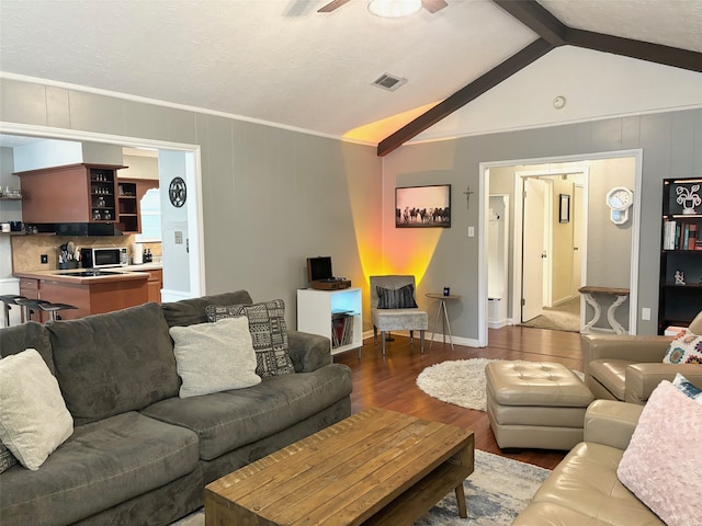 living room featuring ceiling fan, lofted ceiling with beams, crown molding, and hardwood / wood-style floors