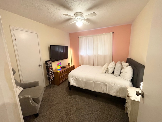 bedroom with ceiling fan, a textured ceiling, and dark carpet