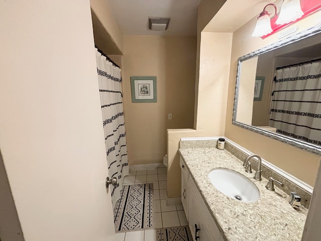 bathroom with vanity, toilet, and tile patterned flooring