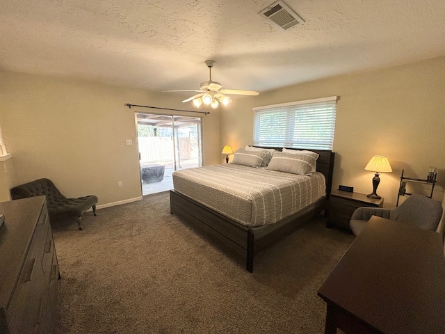 bedroom featuring dark carpet, a textured ceiling, access to exterior, and ceiling fan