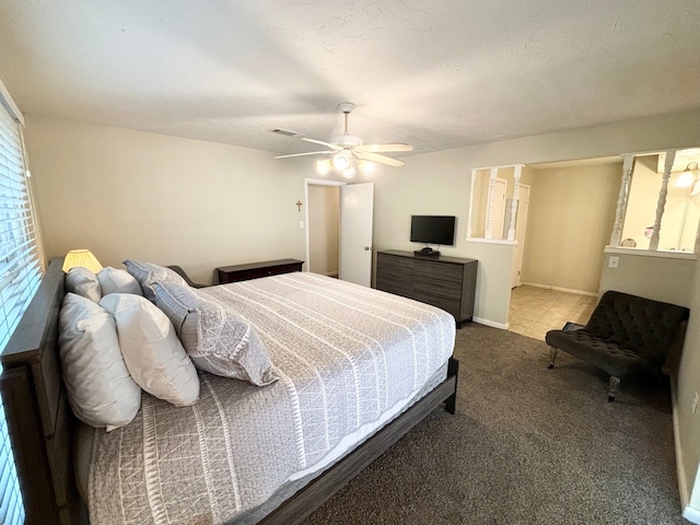 bedroom with carpet floors, a textured ceiling, and ceiling fan