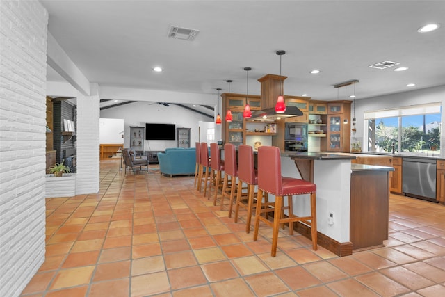 kitchen featuring a breakfast bar, light tile patterned floors, black appliances, and decorative light fixtures