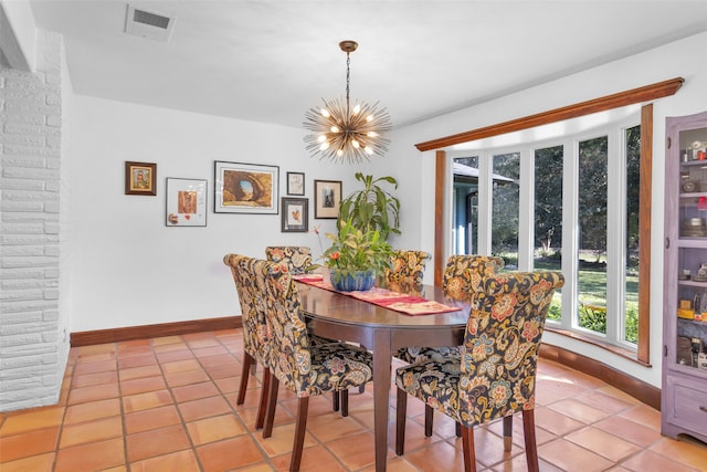 dining space with light tile patterned floors and an inviting chandelier