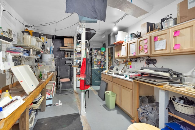 miscellaneous room featuring concrete floors and a workshop area