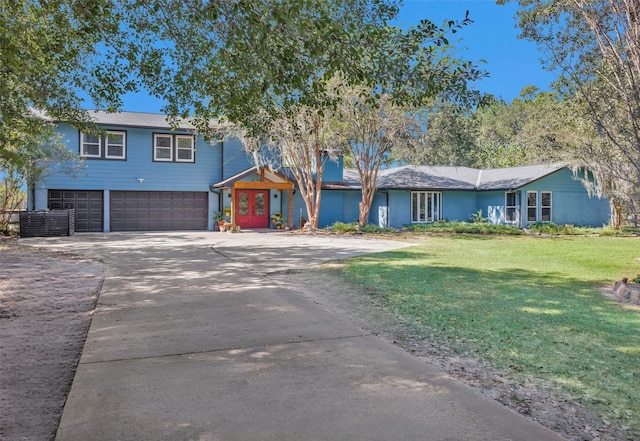 view of front of house with a front yard and a garage