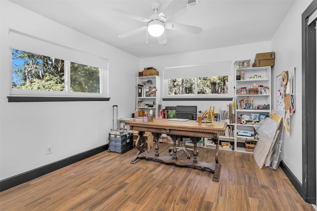 home office with ceiling fan, hardwood / wood-style flooring, and a wealth of natural light