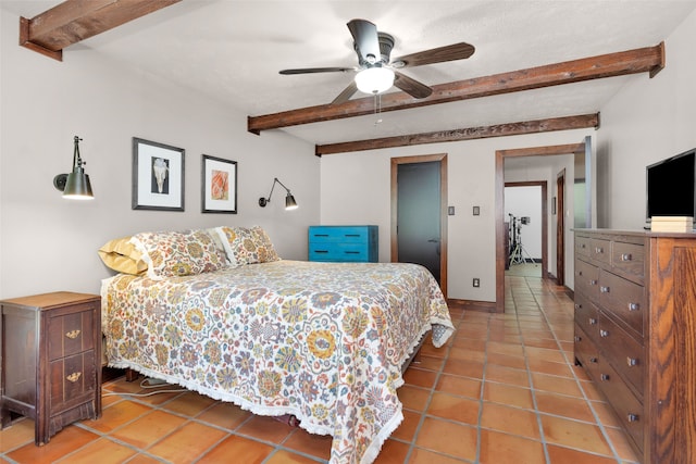 bedroom featuring ceiling fan, beamed ceiling, and tile patterned flooring