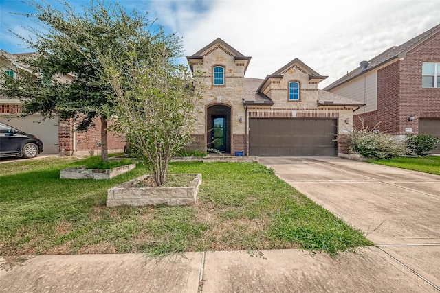 view of front of property featuring a front yard and a garage