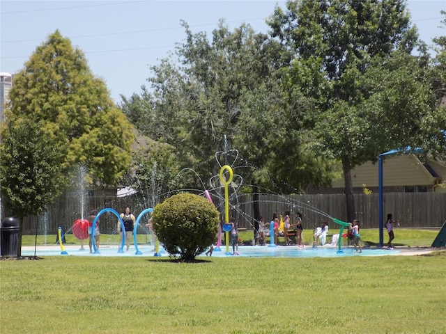 view of property's community with a lawn and a playground