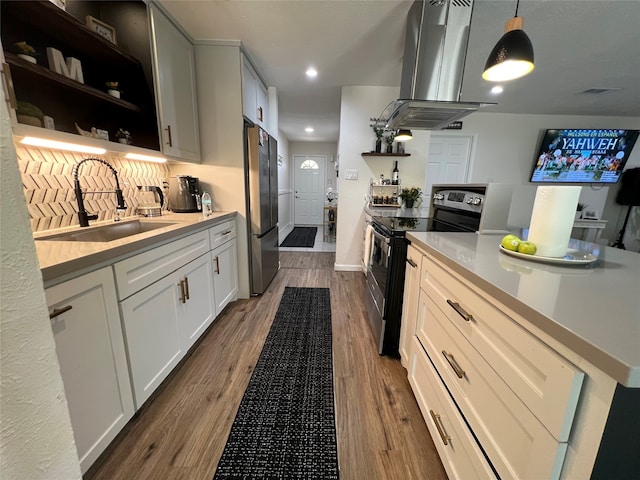 kitchen with white cabinetry, stainless steel appliances, wood-type flooring, and island range hood