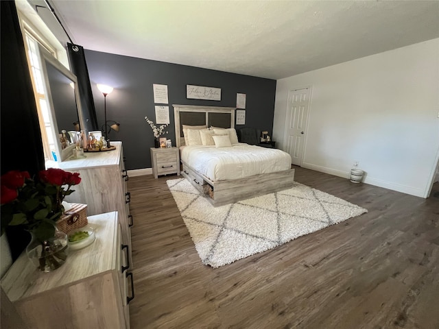 bedroom with dark hardwood / wood-style flooring