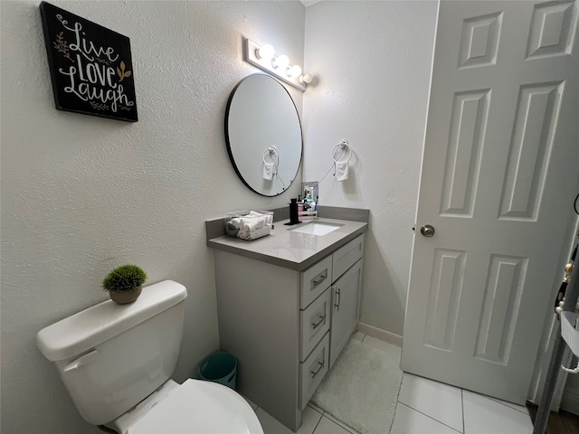 bathroom with vanity, toilet, and tile patterned flooring