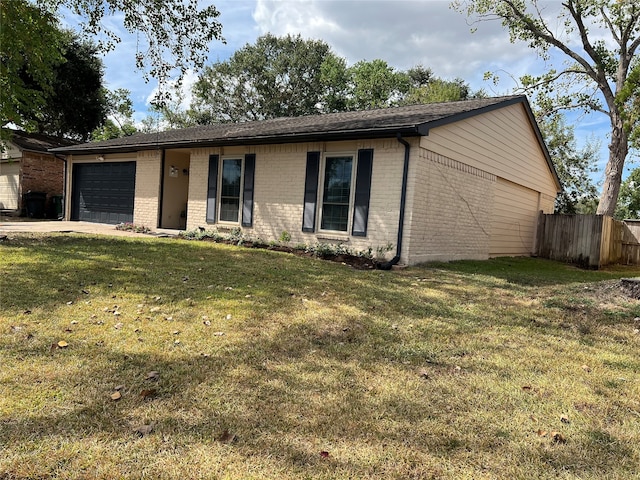 single story home with a front yard and a garage