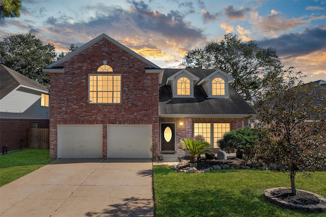 view of front of property featuring a yard and a garage