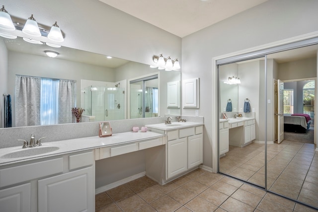 bathroom featuring tile patterned flooring, vanity, and walk in shower