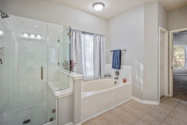 bathroom featuring tile patterned floors, separate shower and tub, and a textured ceiling