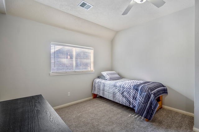 bedroom with carpet flooring, ceiling fan, a textured ceiling, and vaulted ceiling