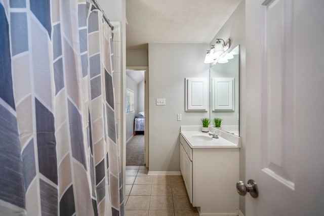 bathroom with tile patterned floors, vanity, and a textured ceiling