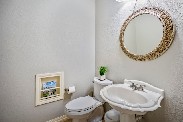 bathroom featuring sink and toilet