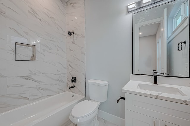 full bathroom featuring tiled shower / bath, vanity, and toilet