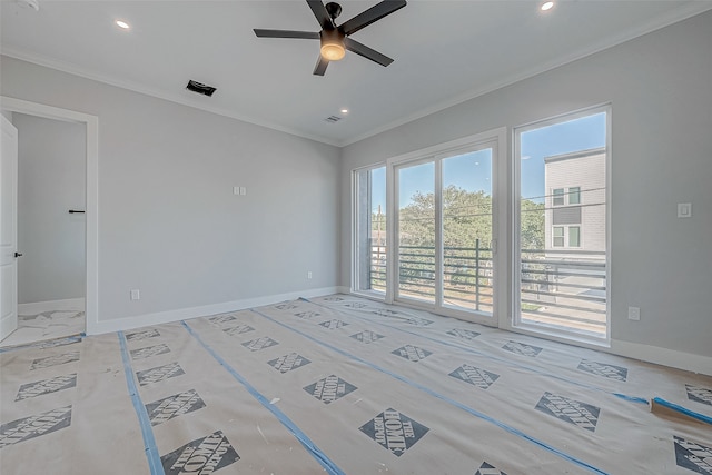 unfurnished room featuring ceiling fan and ornamental molding