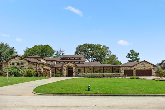 view of front of home featuring a garage and a front lawn