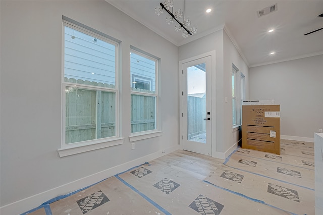 doorway to outside featuring crown molding and a chandelier