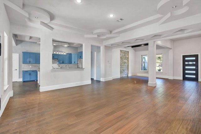 unfurnished living room with dark wood-type flooring