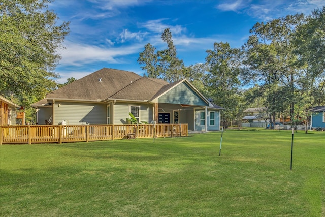 back of house with a lawn and a wooden deck