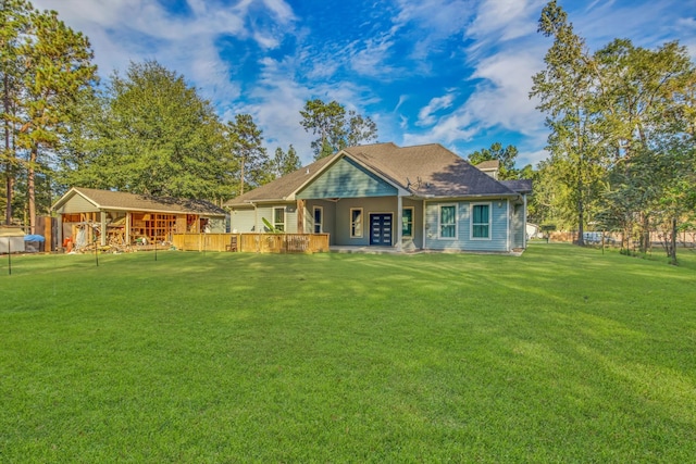 rear view of house featuring a yard